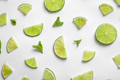 Photo of Composition with fresh ripe limes on white background, top view