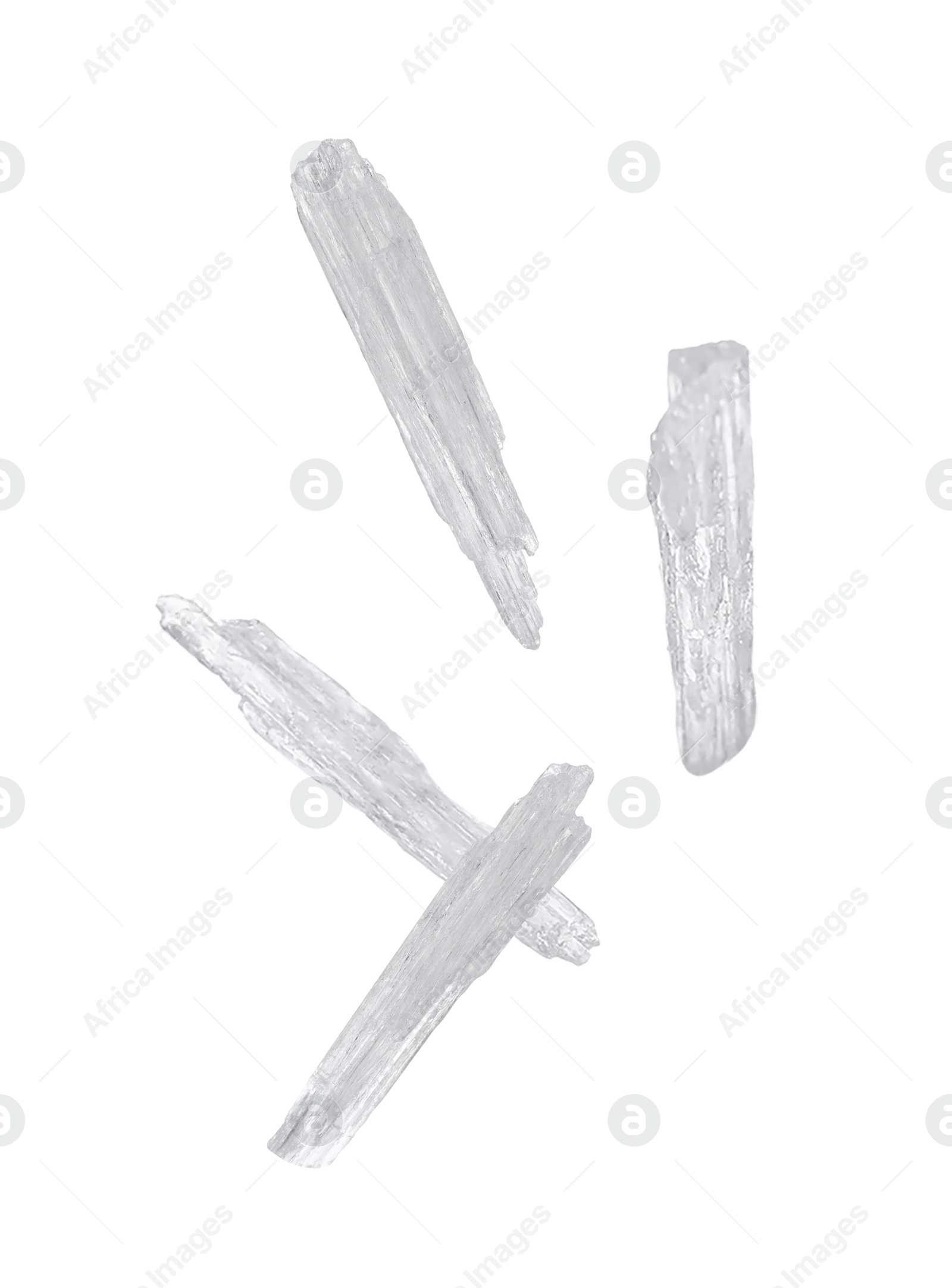 Image of Translucent menthol crystals falling on white background