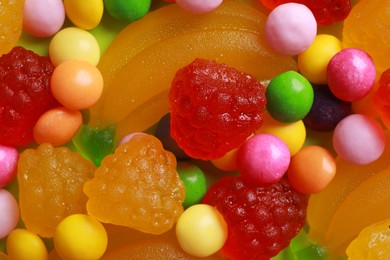 Photo of Delicious dragee and gummy candies, top view