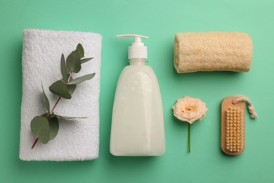 Photo of Flat lay composition with bottle of liquid soap on turquoise background