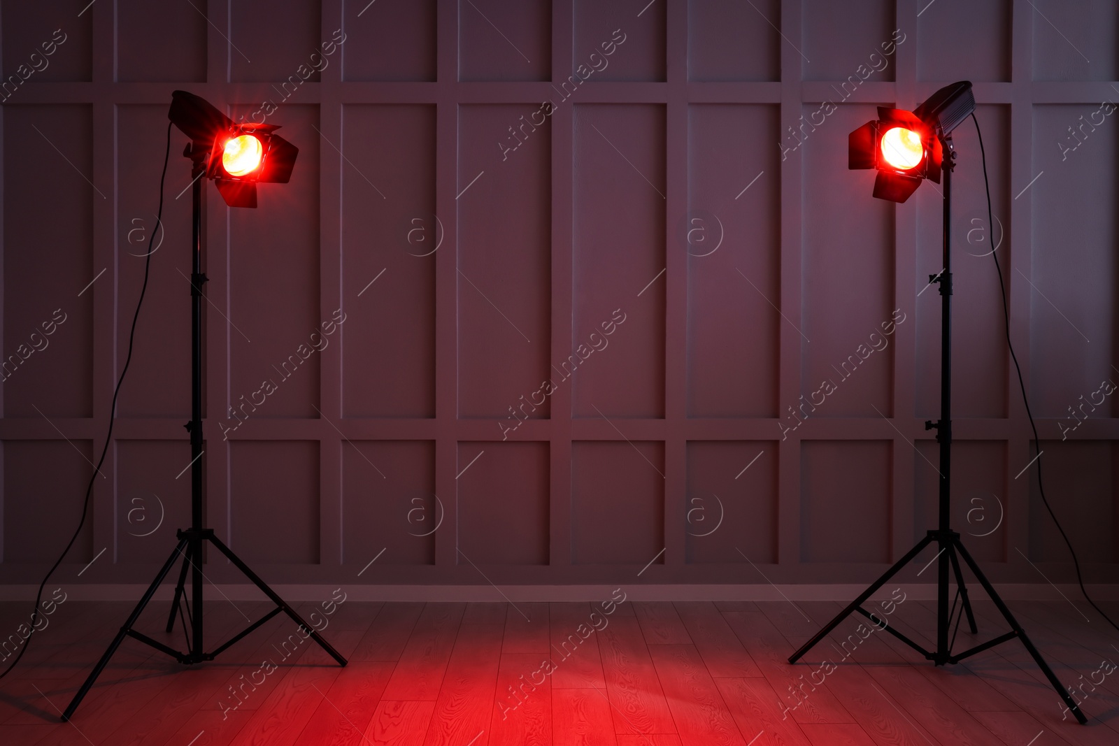 Photo of Bright red spotlights near wall indoors, space for text