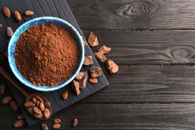 Photo of Flat lay composition with cocoa powder and beans on wooden background