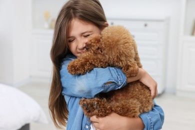 Photo of Little child with cute puppy at home. Lovely pet