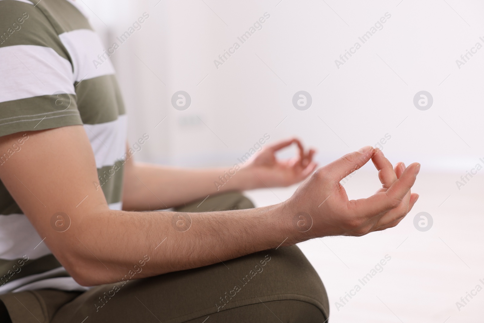 Photo of Closeup view of man meditating on blurred background