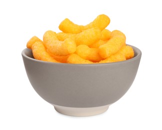 Many tasty cheesy corn puffs in bowl isolated on white