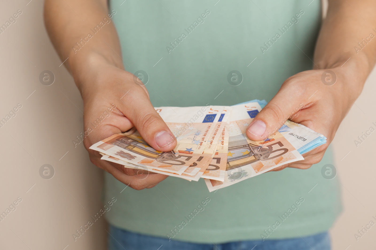 Photo of Man with Euro banknotes on brown background, closeup