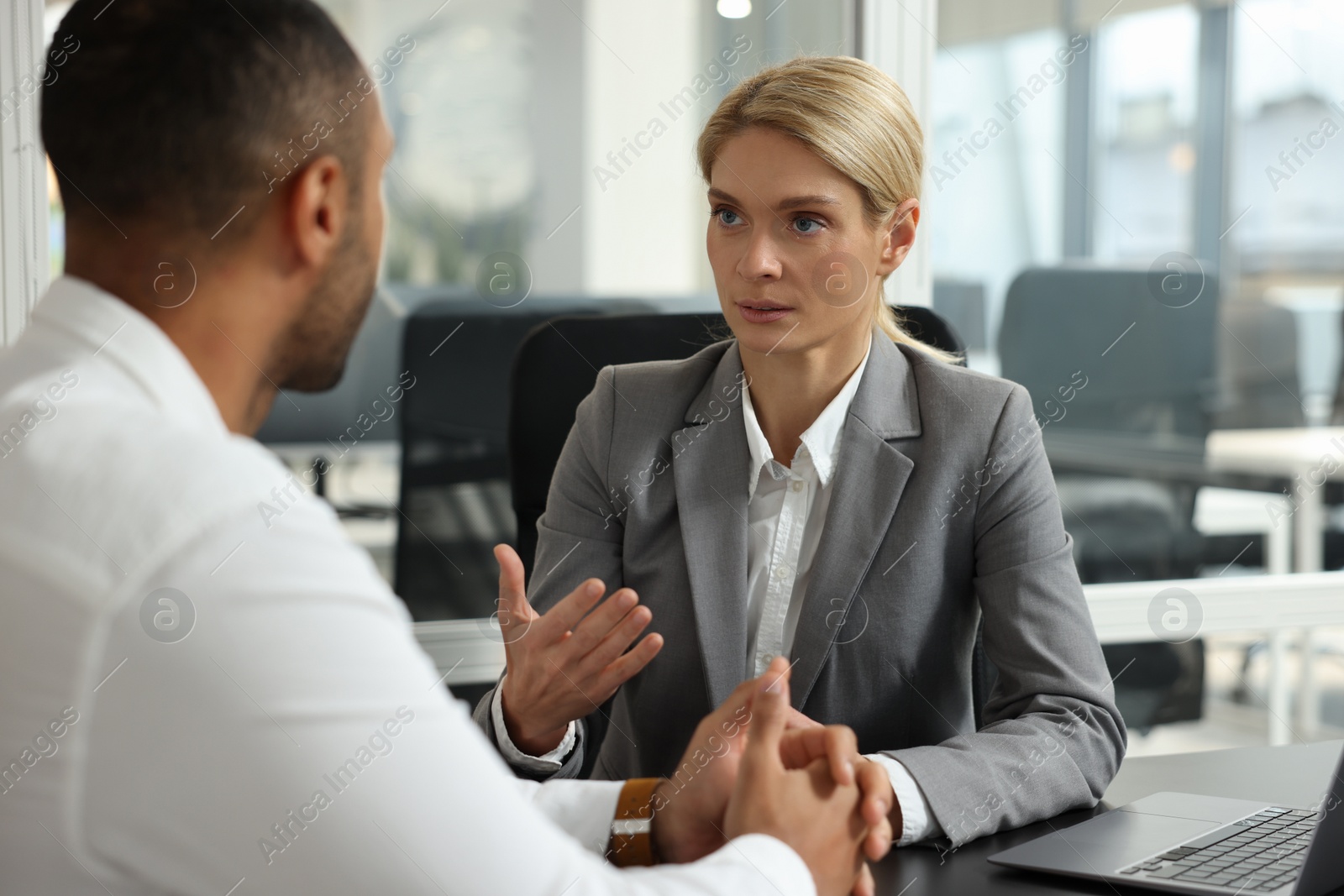 Photo of Lawyer working with client at table in office