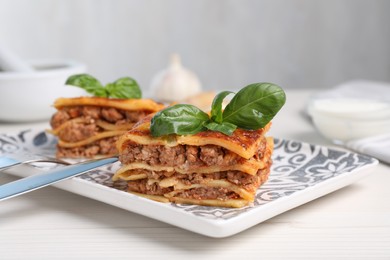 Photo of Delicious lasagna served on white table, closeup