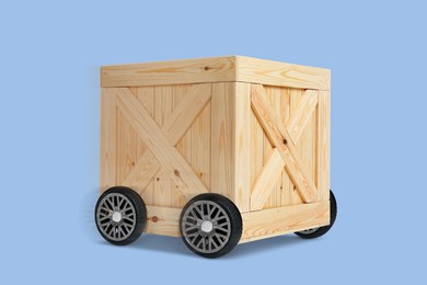 Image of Wooden box on wheels against light blue background. Transportation and delivery service