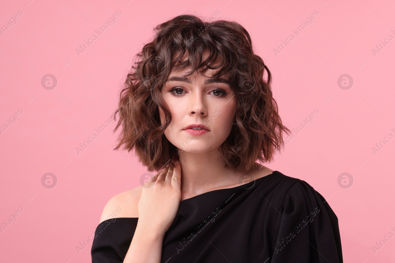 Photo of Portrait of beautiful young woman with wavy hairstyle on pink background