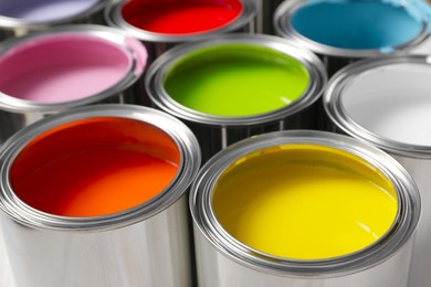 Photo of Cans of different colorful paints as background