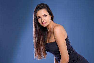 Photo of Portrait of beautiful model with gorgeous straight hair on color background