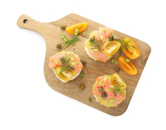 Photo of Tasty canapes with salmon, tomatoes, capers and herbs isolated on white, top view