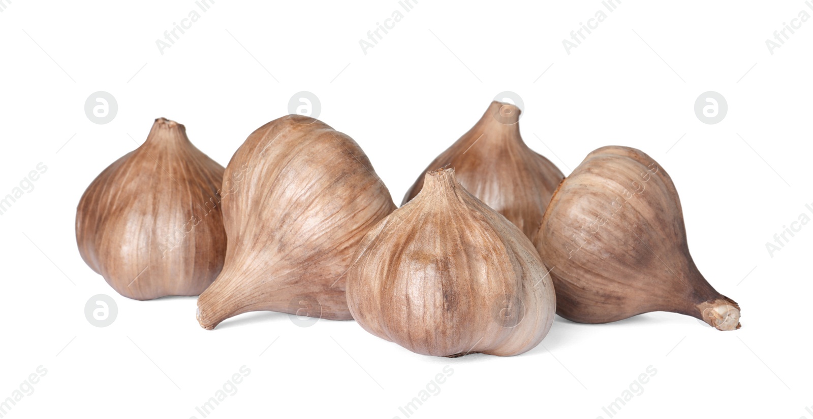Photo of Unpeeled bulbs of black garlic on white background