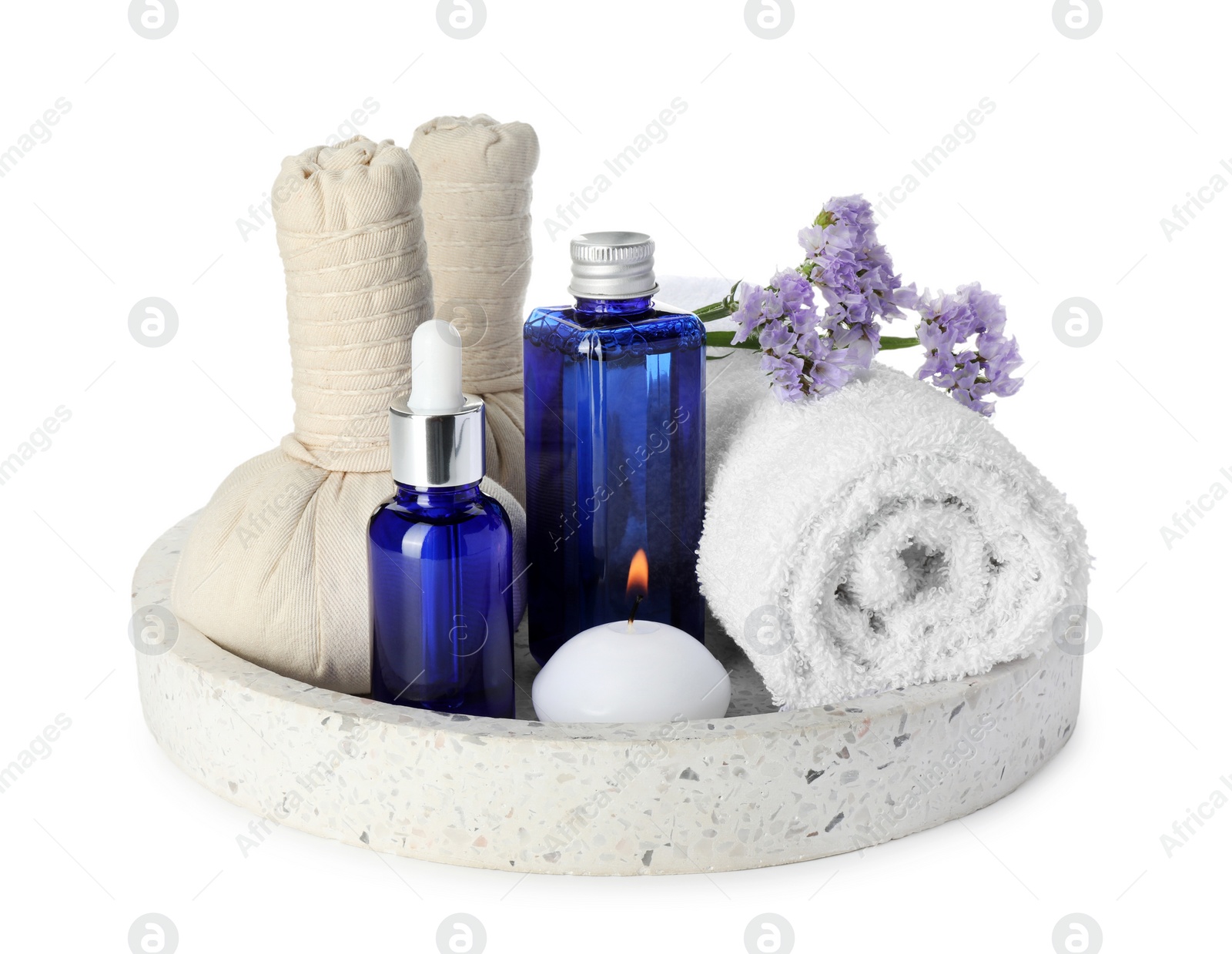 Photo of Spa composition. Bottles of cosmetic products, towel, herbal bags, flowers and burning candle isolated on white