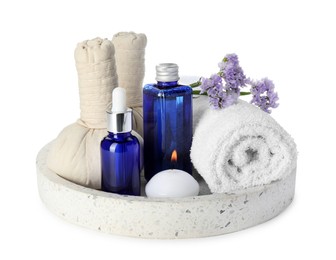 Photo of Spa composition. Bottles of cosmetic products, towel, herbal bags, flowers and burning candle isolated on white