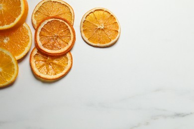 Photo of Dry orange slices on white table, flat lay. Space for text