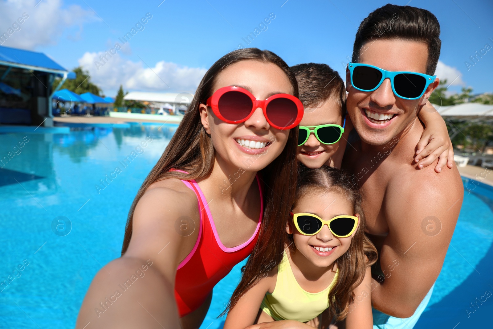 Photo of Happy family taking selfie near swimming pool.  Summer vacation