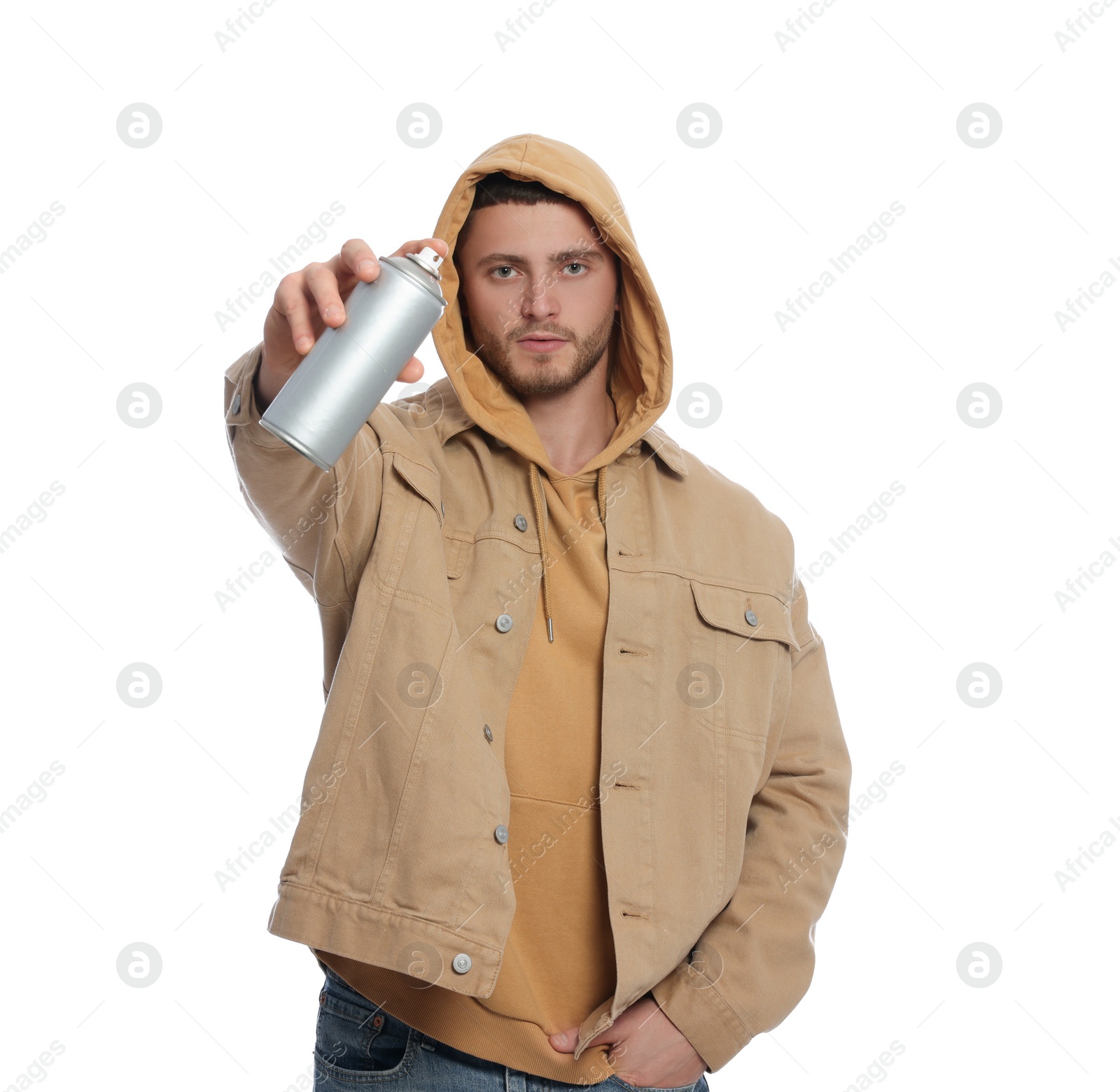 Photo of Handsome man holding can of spray paint on white background