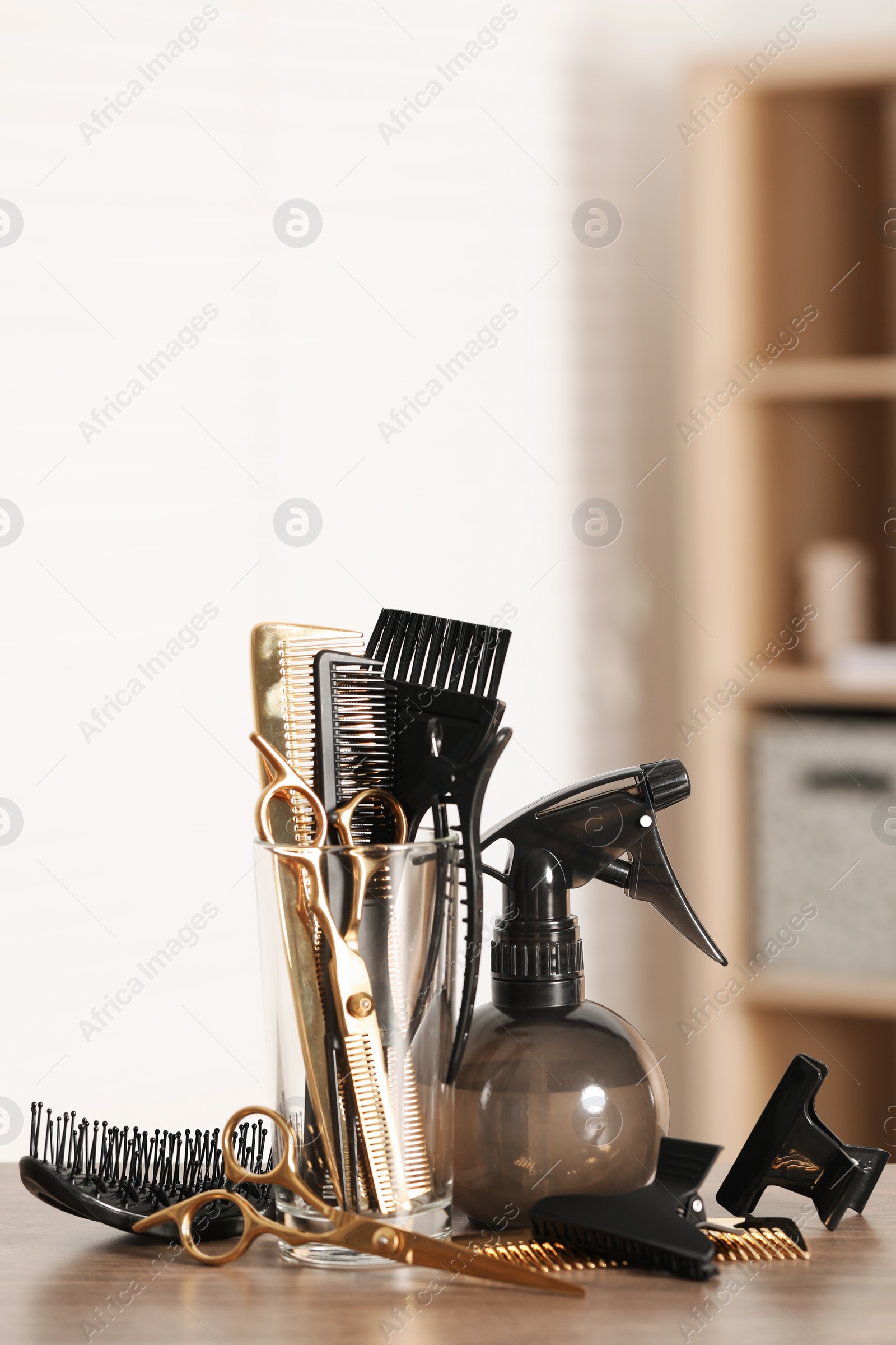 Photo of Set of hairdresser tools on table in salon