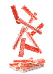 Image of Many fresh crab sticks falling on white background