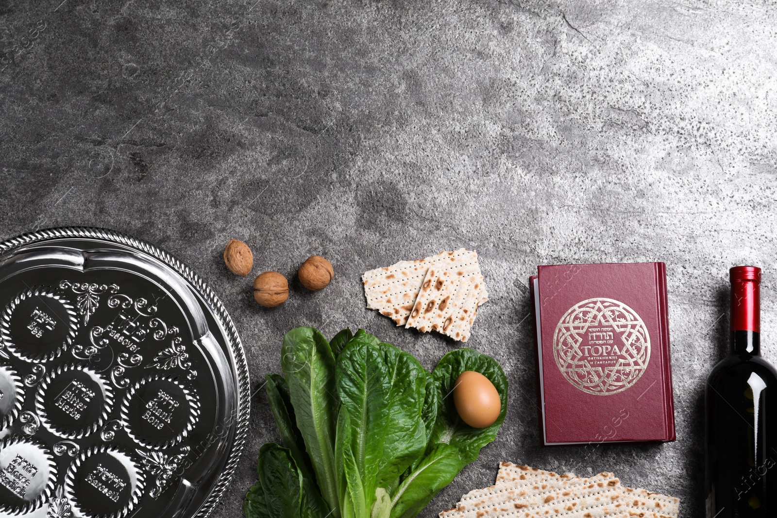 Photo of Flat lay composition with Passover Seder plate (keara) on grey table, space for text. Pesah celebration