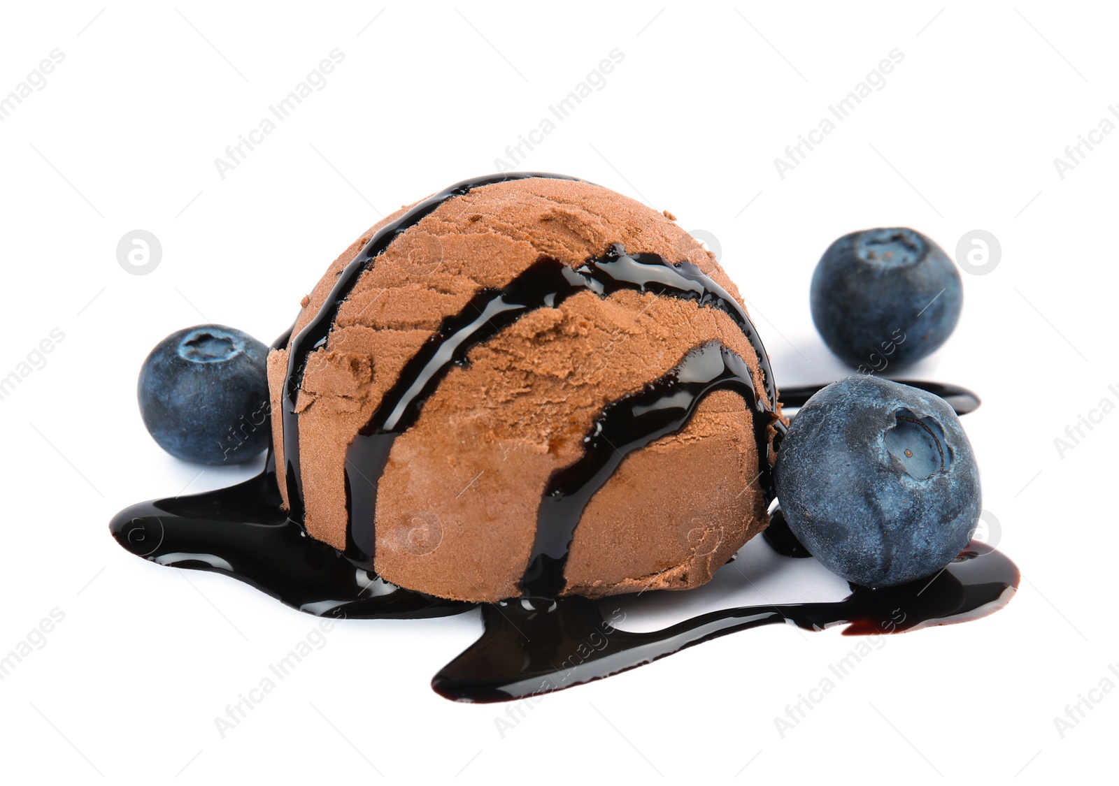 Photo of Scoop of chocolate ice cream with syrup and blueberries isolated on white