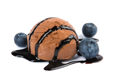 Scoop of chocolate ice cream with syrup and blueberries isolated on white