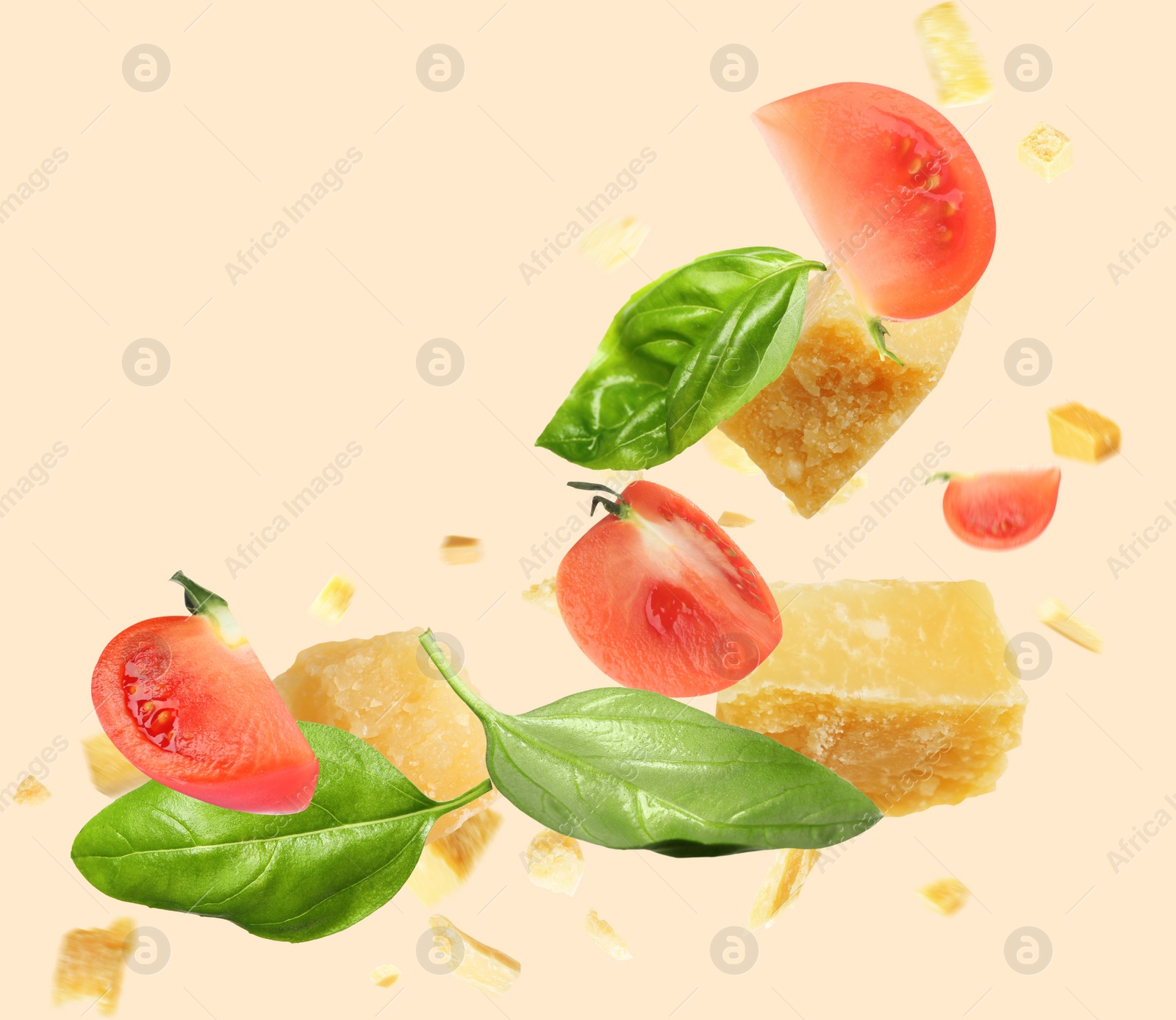 Image of Pieces of delicious parmesan, tomatoes and basil leaves falling on beige background