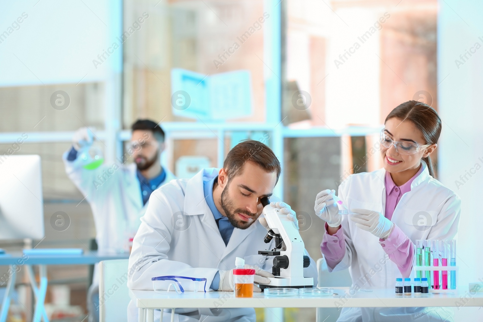 Photo of Young scientists working in laboratory. Chemical analysis