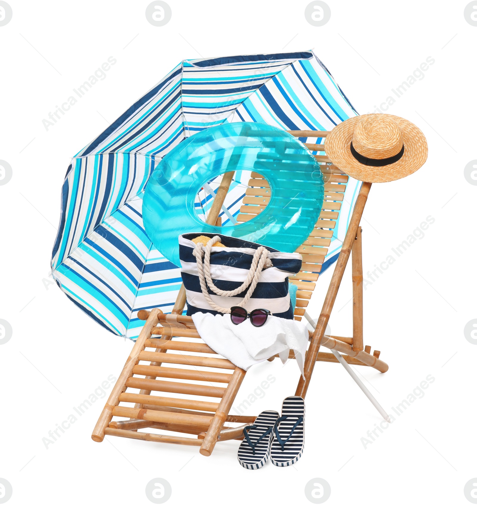 Photo of Deck chair, umbrella and other beach accessories isolated on white