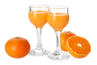 Photo of Tasty tangerine liqueur in glasses and fresh citrus fruits isolated on white