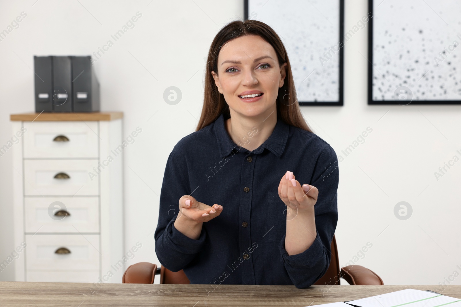 Photo of Woman having video chat at wooden table in office, view from web camera