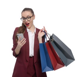Photo of Excited young businesswoman with shopping bags and smartphone on white background