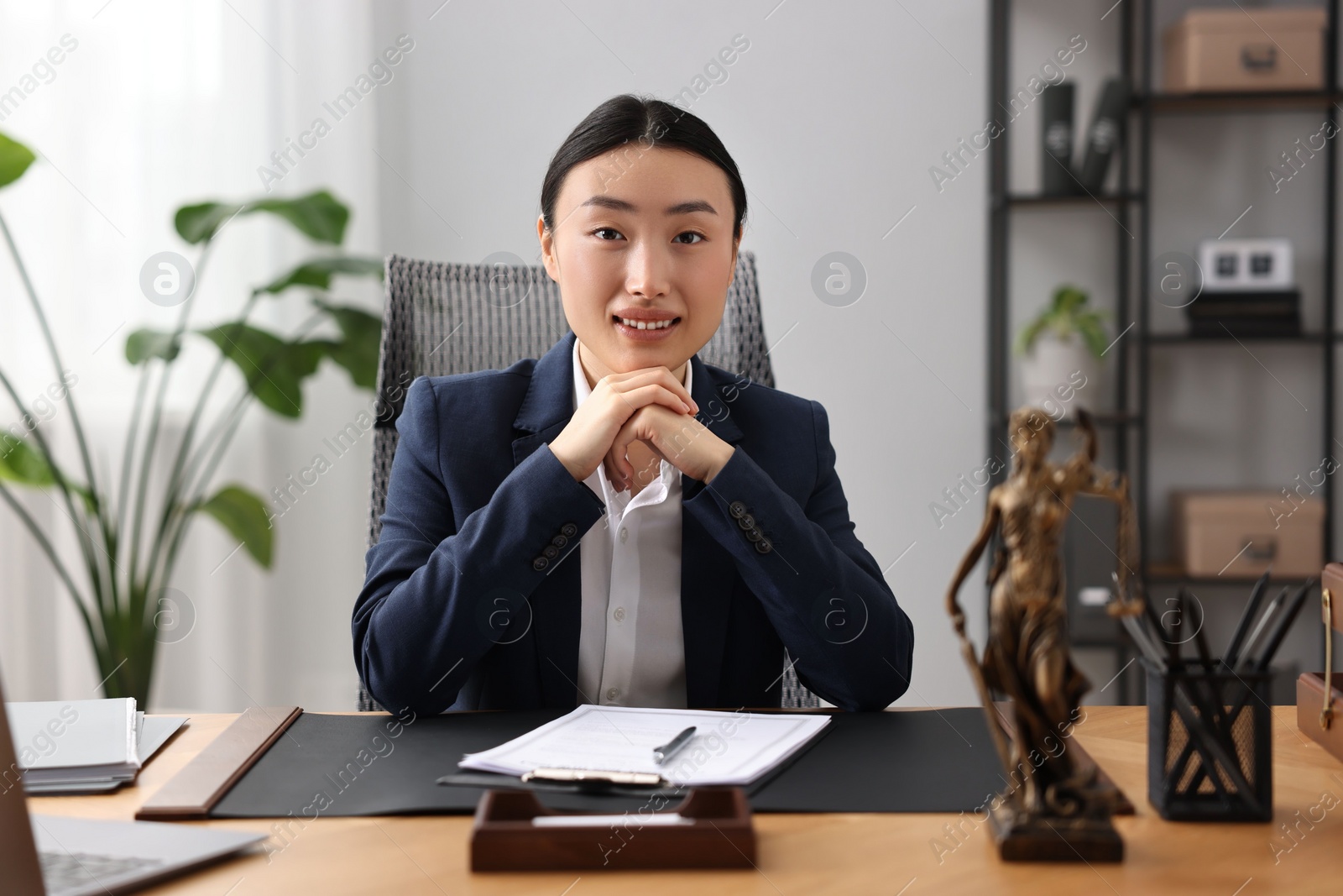 Photo of Portrait of smiling notary at table in office