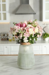 Photo of Beautiful bouquet of fresh flowers in vase on table indoors