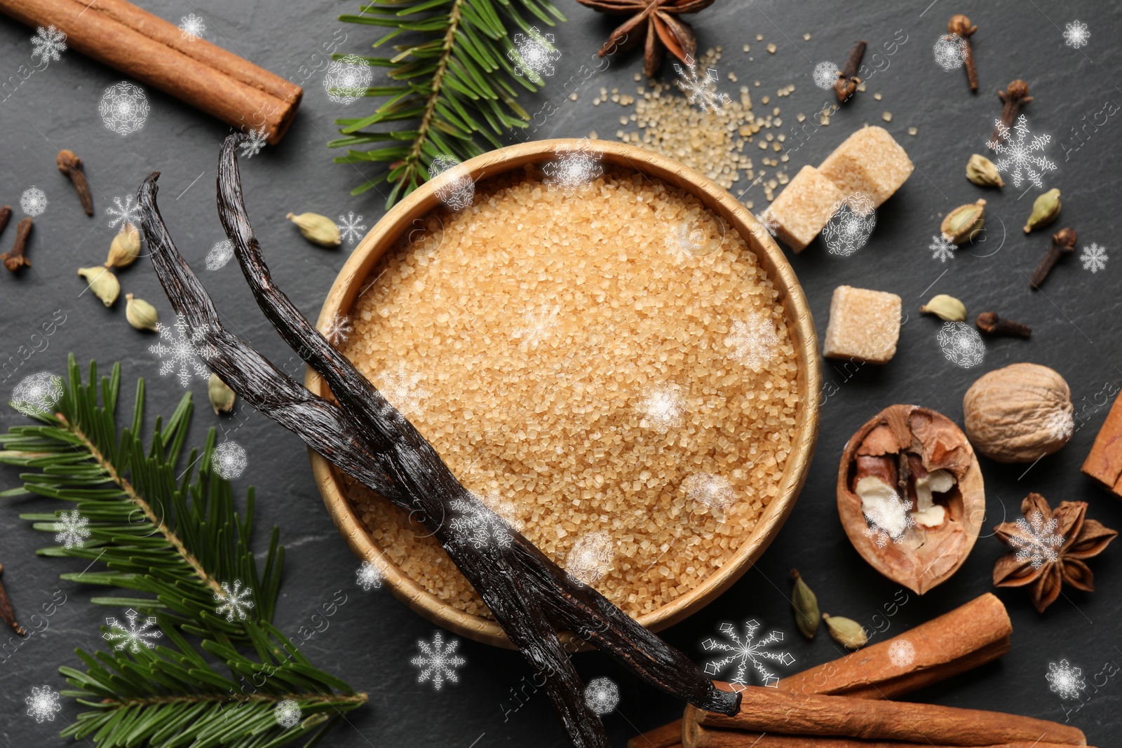 Image of Different spices and fir tree branches on black table, flat lay. Brown sugar, vanilla, cinnamon, anise, cardamom, cloves