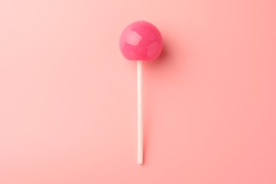 Tasty lollipop on pink background, top view