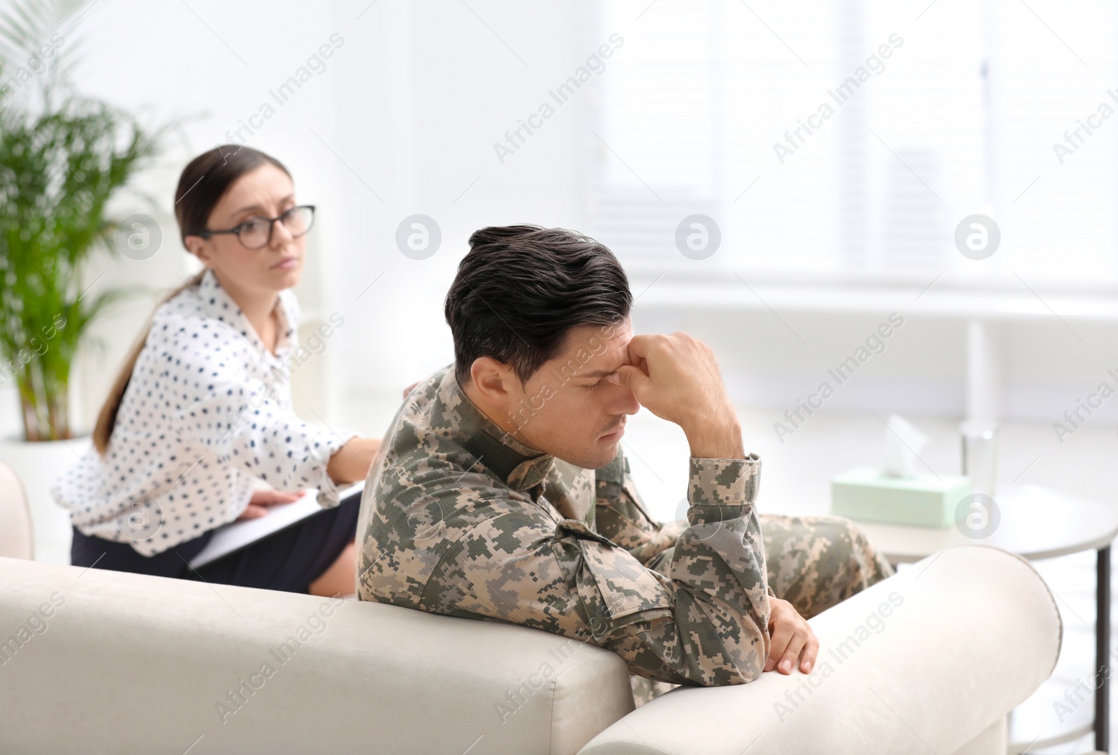 Photo of Psychotherapist working with male military officer in office