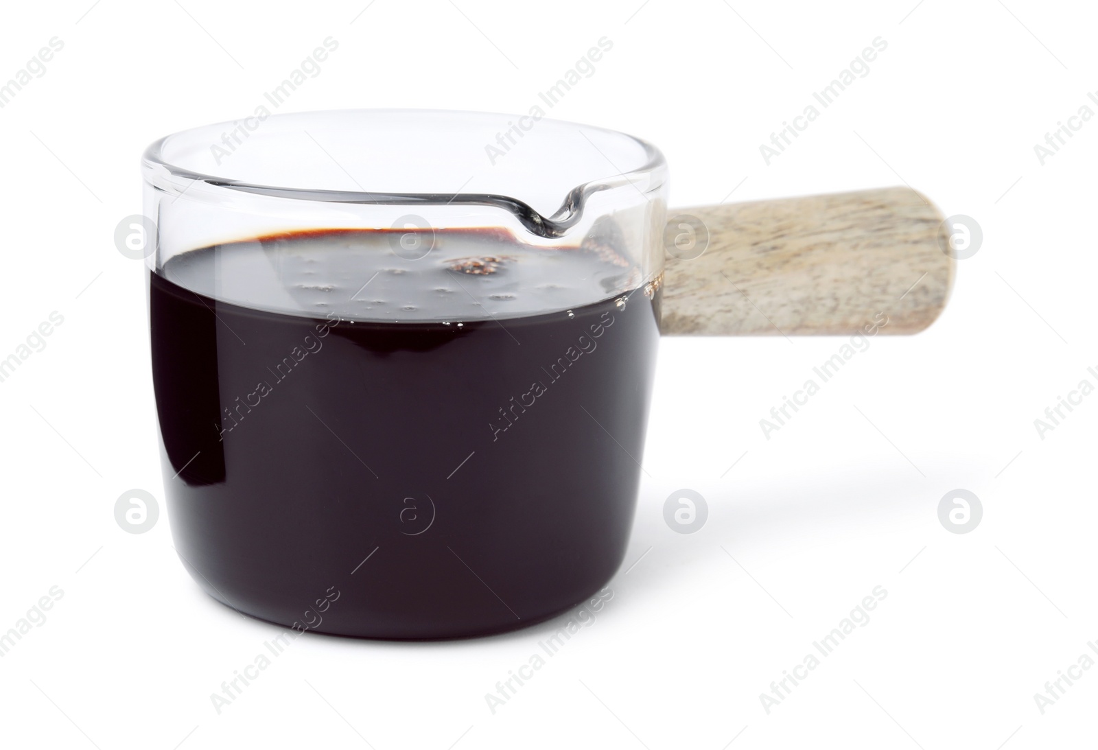 Photo of Tasty pomegranate sauce in glass isolated on white