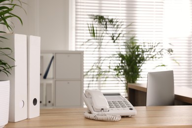 Telephone on wooden desk at hospital reception