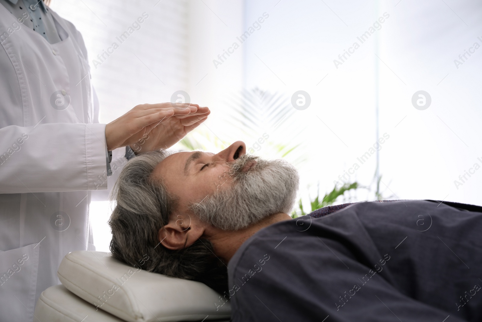 Photo of Psychotherapist and patient in office. Hypnotherapy session