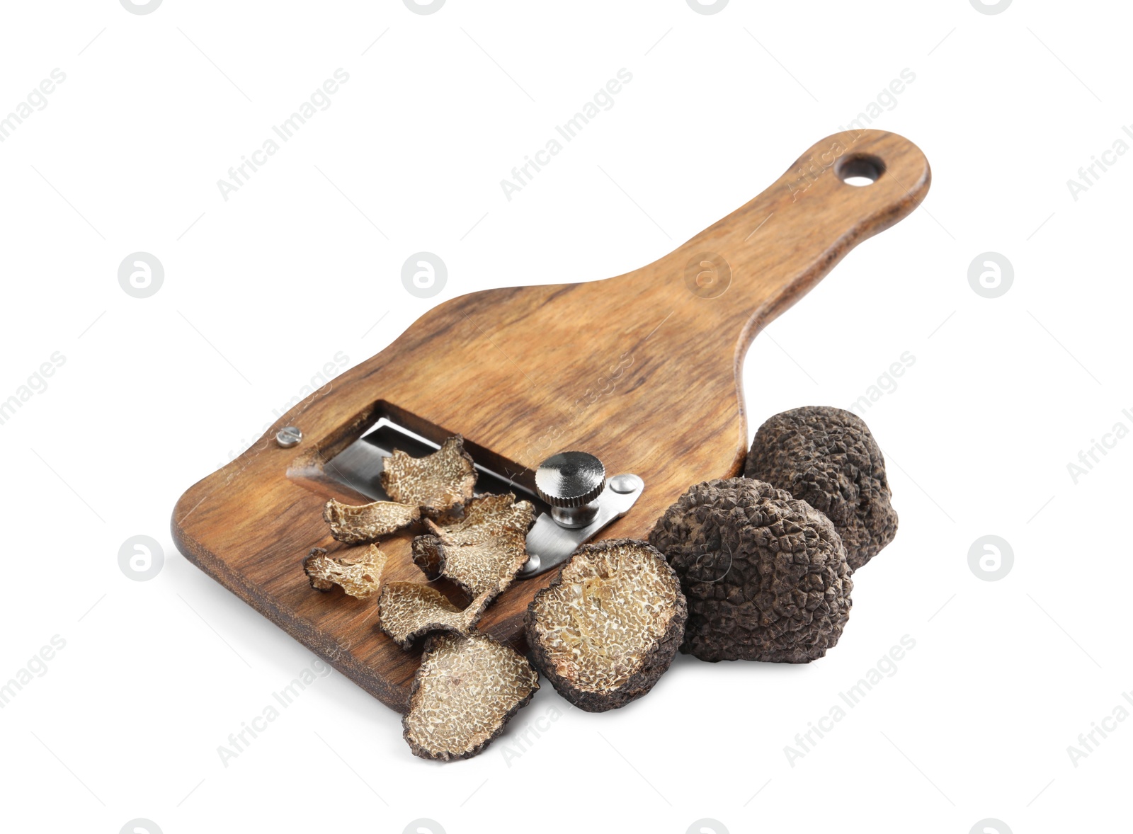 Photo of Wooden shaver with whole and sliced black truffles on white background