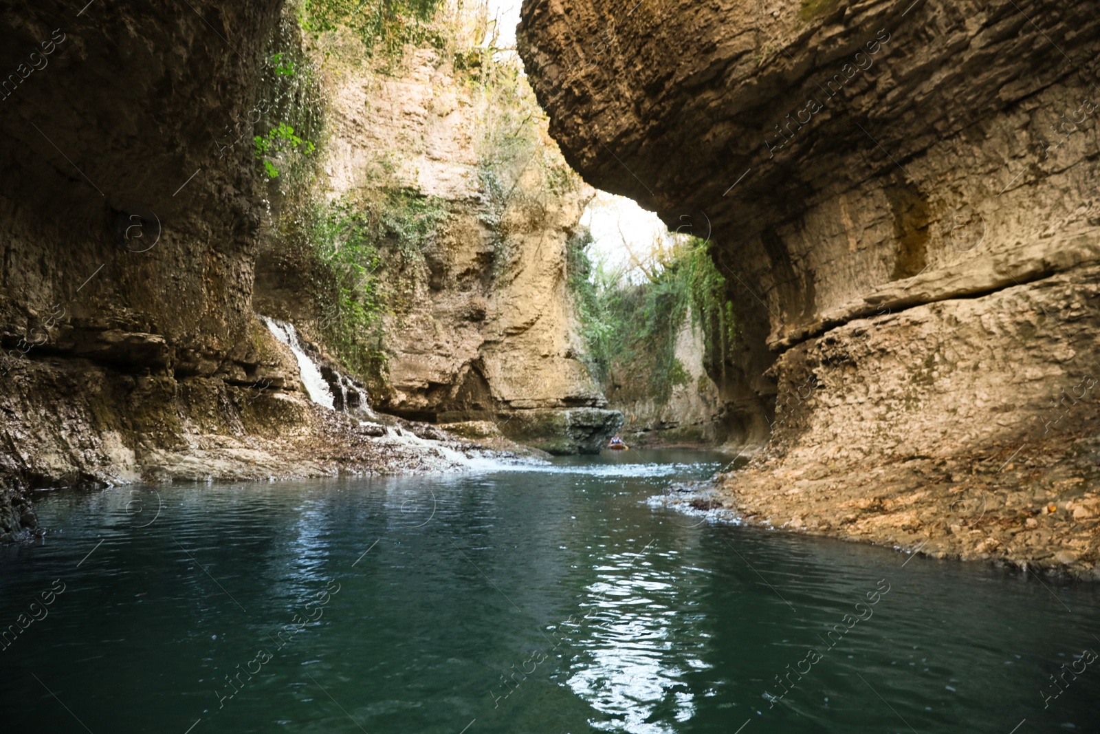 Photo of Picturesque view of clean river near cliffs and waterfall outdoors