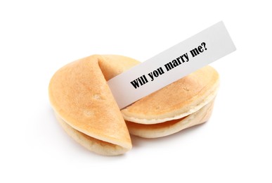 Image of Tasty fortune cookie and paper with phrase Will you marry me? on white background