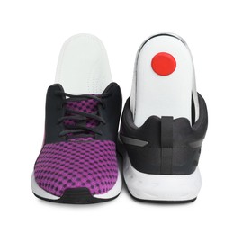 Photo of Orthopedic insoles in shoes on white background
