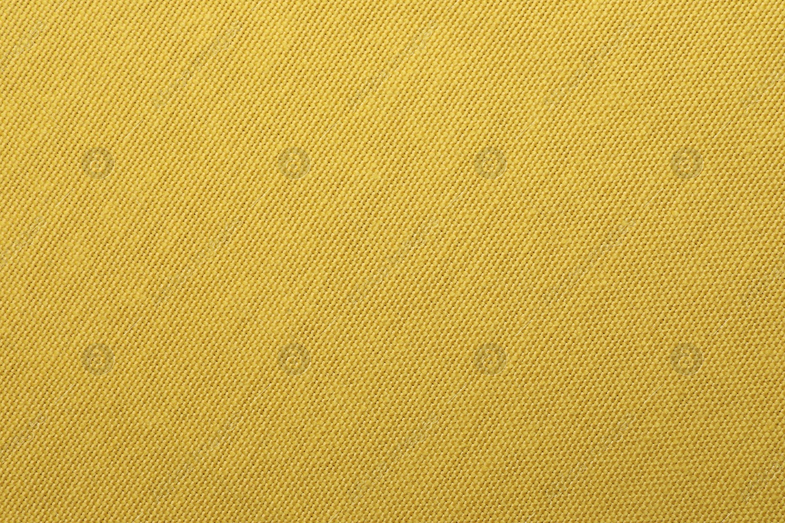 Photo of Texture of yellow fabric as background, top view