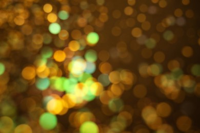 Blurred view of shiny lights on dark background. Bokeh effect