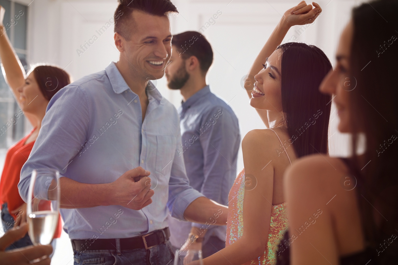 Photo of Lovely young couple dancing together at party