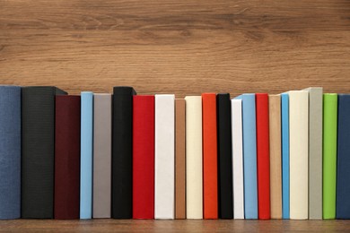 Many different hardcover books on wooden background